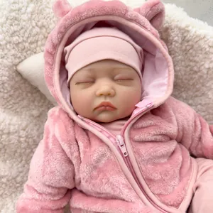 Lifelike 55cm newborn reborn baby doll in pink plush hooded outfit sleeping on soft fur