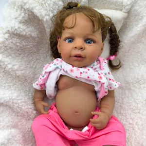 Realistic 19-inch reborn baby doll with curly brown hair, blue eyes and floral pink outfit