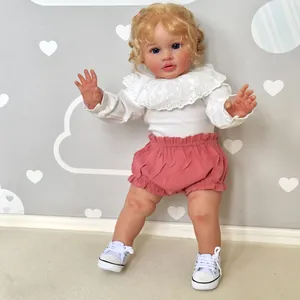 Close-up of 26-inch Reborn baby doll with curly blonde hair and detailed skin texture