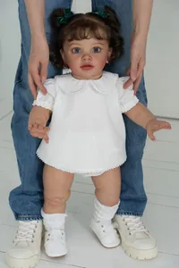 Detailed view of 26-inch lifelike reborn toddler doll in white lace outfit and shoes