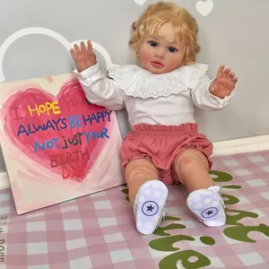 Lifelike 26-inch Pippa reborn baby doll with blonde hair and pink outfit in a cozy nursery