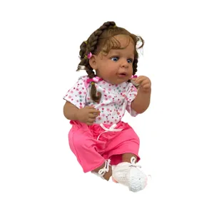 Realistic 19-inch reborn baby doll with brown skin, curly hair and floral white top
