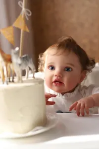 Macro detail of 60cm reborn doll featuring realistic blue eyes and soft curly hair