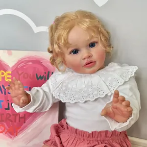 Realistic 26-inch Reborn baby doll with blonde curls and pink outfit in cozy nursery setting