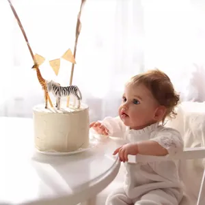 Lifelike 60cm reborn baby doll with visible veins and blue eyes in white lace outfit