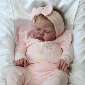 60cm realistic reborn baby doll in pink long sleeve outfit sleeping on white silk