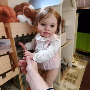 26-inch lifelike reborn baby doll Pippa in pink floral outfit in a dollhouse