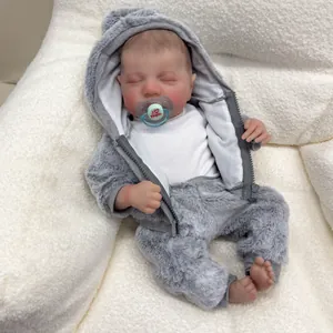 Close-up of lifelike Levi reborn doll in grey plush hoodie with I love papa pacifier