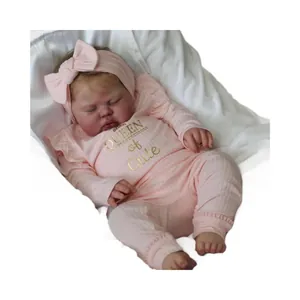 60cm reborn baby doll in pink ribbed outfit with Queen of Cute print and bow headband