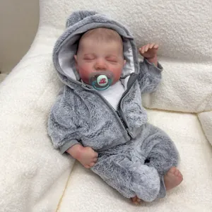 Realistic 49cm Levi reborn baby doll in grey plush hoodie sleeping on white fur