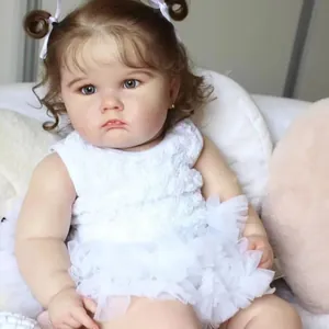 Poupée Charlotte Reborn réaliste 60cm avec boucles brunes et robe en dentelle blanche