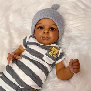Realistic 23-inch African-American reborn baby doll Jaylan wearing striped romper and hat