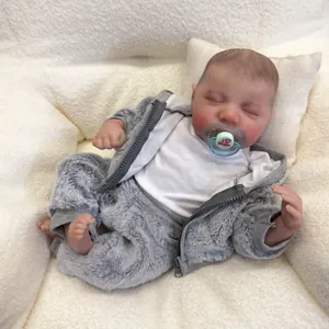 Realistic 49cm sleeping Levi reborn baby doll in grey plush hoodie on soft white bedding