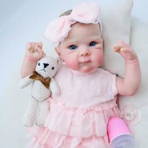 Realistic 18-inch Bettie reborn baby doll with blue eyes and pink polka dot dress