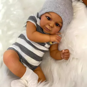 Detailed view of Jaylan 23-inch reborn baby doll featuring realistic dark skin and knit outfit