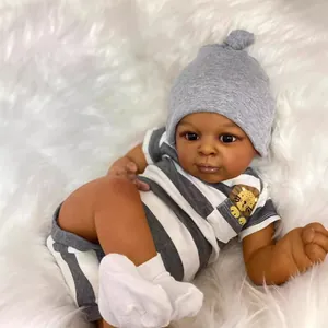 Realistic 23-inch deep skin tone reborn baby doll wearing a lion striped romper and knit hat