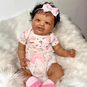 Realistic 60cm dark skin reborn baby doll in pink floral outfit on white faux fur carpet