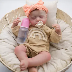 Realistic 19-inch reborn baby doll Loulou sleeping in basket with rainbow romper and pacifier