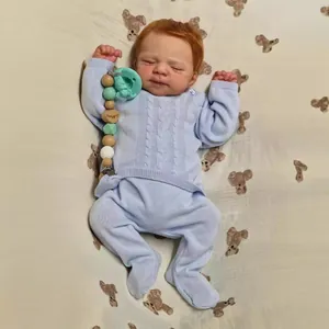 Realistic 19 inch reborn baby doll in blue knit outfit with pacifier and beaded clip