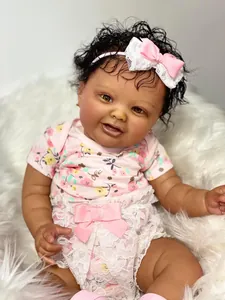 Close-up of realistic 60cm reborn baby doll with dark skin, curly hair and floral outfit