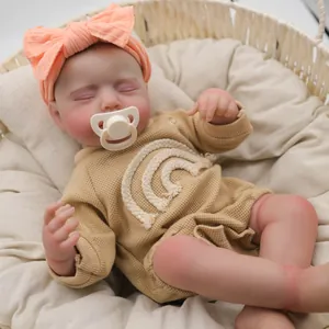 Realistic 19-inch reborn baby doll Loulou sleeping in basket with rainbow romper and pacifier
