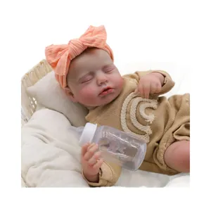 Lifelike 19-inch reborn baby doll sleeping in wicker basket with bottle accessory
