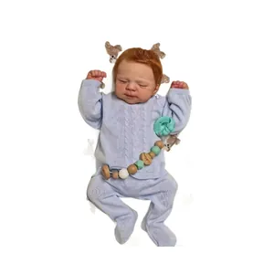 Realistic 19-inch reborn baby doll sleeping in blue knit outfit with pacifier clip