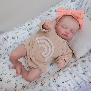Realistic 48cm Rosalie reborn baby doll in beige knit romper sleeping on floral nest