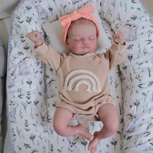 Realistic 48cm Rosalie reborn baby doll sleeping in a floral nest with rainbow onesie