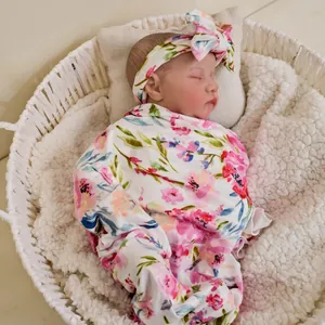 Realistic 49cm Levi reborn baby doll with 3D skin and visible veins in floral swaddle