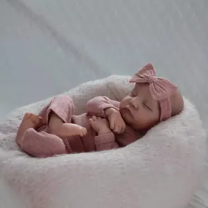 Lifelike 19 inch reborn baby doll Levi with 3D skin in pink knitted sleeper and headband