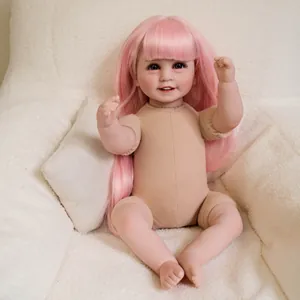 Realistic reborn baby doll with long pink hair and blue eyes on a soft white sofa