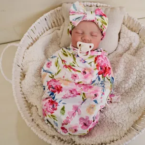49cm reborn baby doll Levi with realistic 3D skin and floral wrap in a woven basket