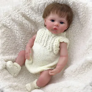 Realistic 18-inch reborn baby doll with blue eyes, short brown hair and knit outfit