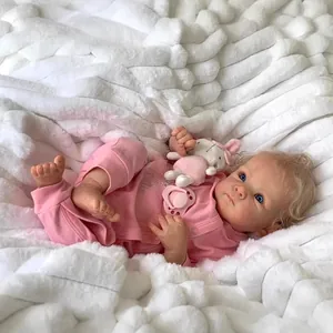 48cm Bettie reborn baby doll with blonde hair and pink outfit lying on a soft white rug