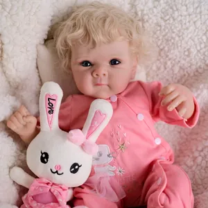 Realistic 48cm reborn baby doll with blonde curls, pink outfit and plush bunny accessory