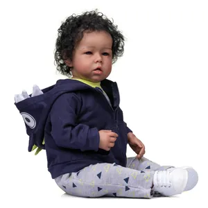 52cm Liam reborn baby doll with dark skin, curly black hair and dinosaur themed outfit