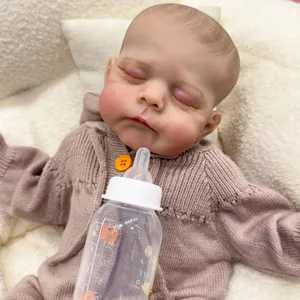 19-inch realistic reborn baby doll Erica sleeping in pink knit cardigan with baby bottle