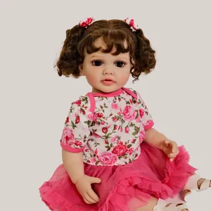 55cm Betty reborn baby doll with curly brown pigtails in a pink floral tutu dress