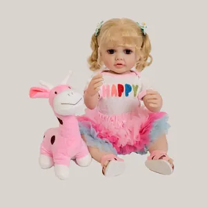 55cm reborn baby doll with blonde curls and pink tutu next to a plush giraffe toy
