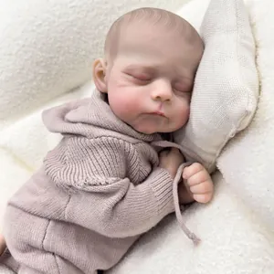 19-inch Erica reborn baby doll in pink knitted romper sleeping on white fleece
