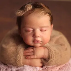 Lifelike 19 inch reborn sleeping baby doll with brown hair and knit sweater
