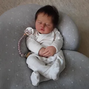 Lifelike 19-inch reborn sleeping baby doll in white romper with moon pillow and pacifier
