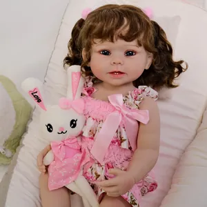 Lifelike 55cm Reborn baby doll in pink floral lace dress with a plush rabbit toy
