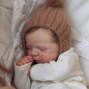 50cm lifelike reborn baby doll wearing a brown mohair pointed hat and white knit bodysuit
