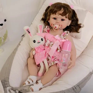 55cm Reborn baby doll Bonnie with curly brown hair, floral pink dress, and plush rabbit toy