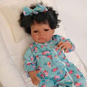 Close-up of 19-inch lifelike deep skin baby doll with curly hair and blue floral outfit