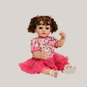 55cm realistic reborn baby doll with curly brown hair wearing a floral dress and pink tutu