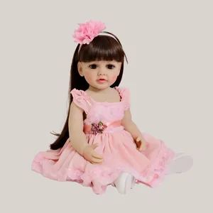Reborn baby doll Betty in pink lace dress and floral headband on grey background