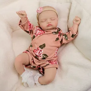 Realistic 18-inch sleeping reborn baby doll in pink floral romper with lace socks